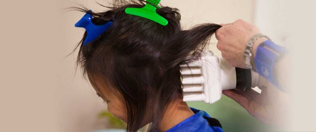 AirAlle device in use for head lice removal
